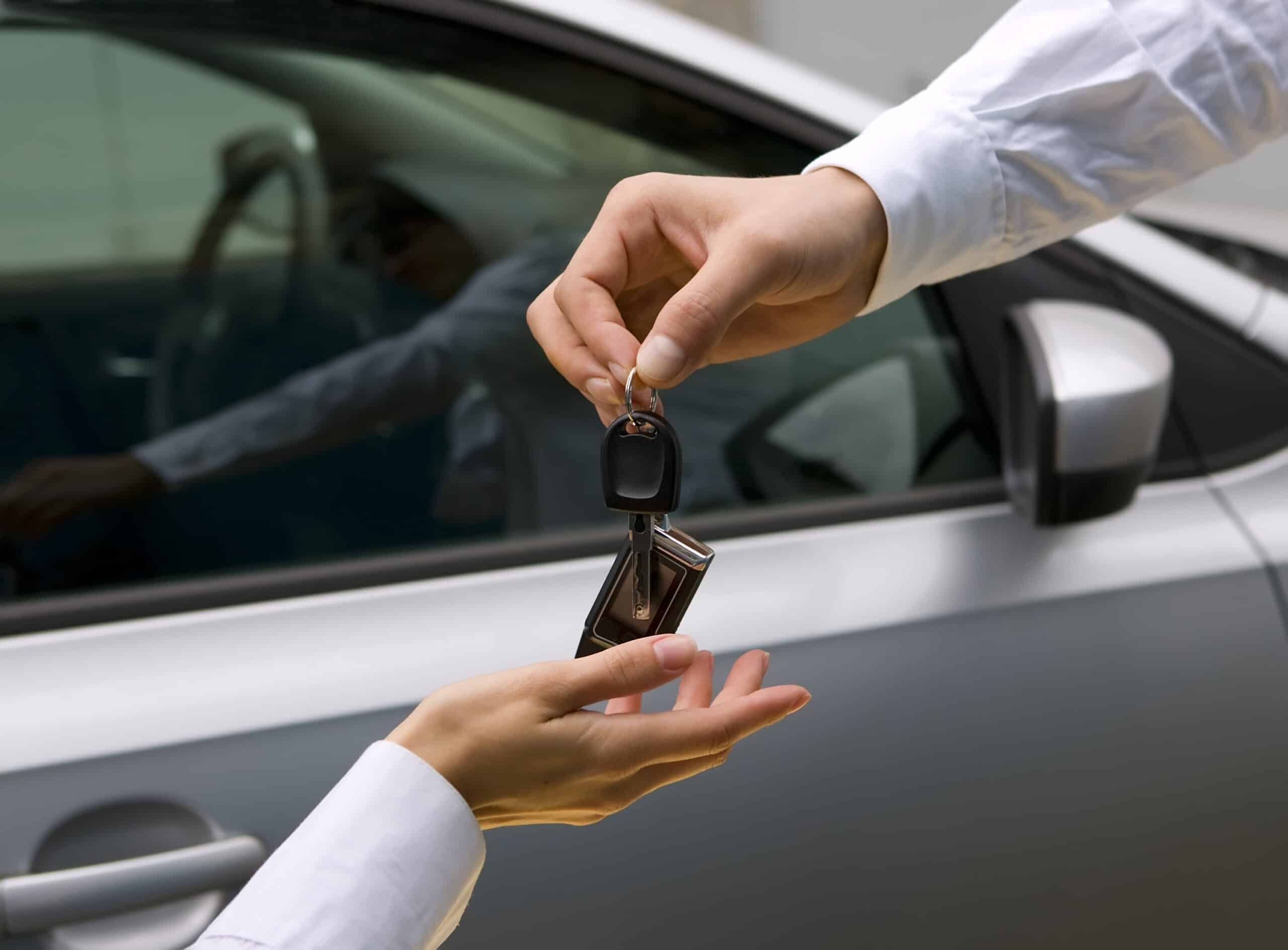 woman receiving car key from a man
