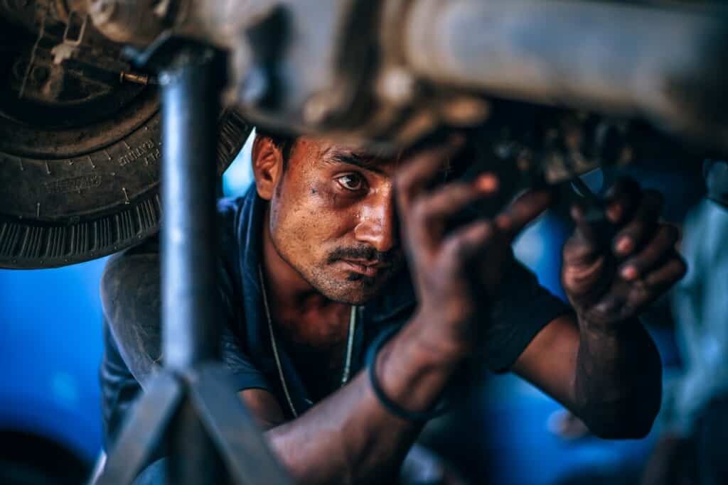 mechanic working on lifted car